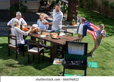 family having barbecue while celebrating 4th july together, Independence Day concept