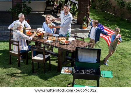 family having barbecue while celebrating 4th july together, Independence Day concept