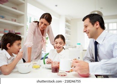 Family Having Breakfast Before Husband Goes To Work