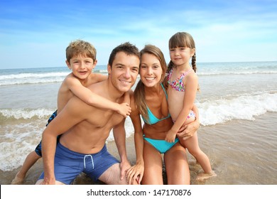 Family Having Fun At The Beach