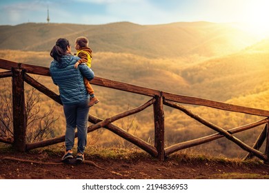 Family Having Fun In The Forest After The Rain On Autumn Day. Hiking Is Fun And Healthy.