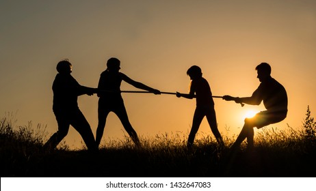 Family having fun in nature - playing tug of war - Powered by Shutterstock