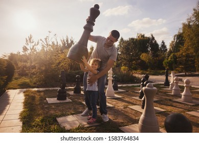 Family having fun near giant chess piece. - Powered by Shutterstock