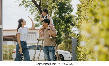 Family Having Fun Time At Home. Asian Family With Little Kids Daughter Playing Together In House Backyard Outside. Happy Family Time.