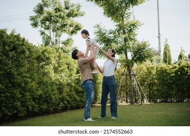 Family Having Fun Time At Home. Asian Family With Little Kids Daughter Playing Together In House Backyard Outside. Happy Family Time.