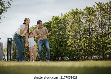 Family Having Fun Time At Home. Asian Family With Little Kids Daughter Playing Together In House Backyard Outside. Happy Family Time.