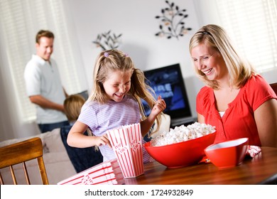 Family Having Home Theater Movie Night With Popcorn.