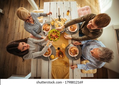 Family Having Lunch Together At Home. View From Above