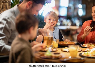 A Family Having A Meal Together In A Restaurant.