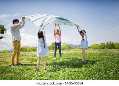 Family Having A Picnic In The Park