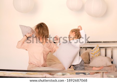 Similar – Image, Stock Photo Relaxed mother and sons playing over the bed
