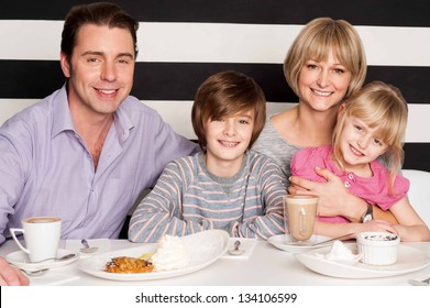 Family Having Rich Breakfast In Restaurant.