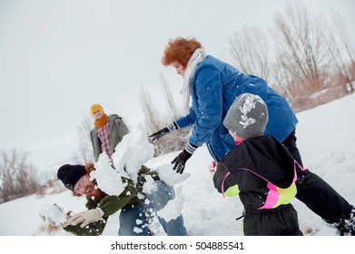 Family Having Snowball Fight