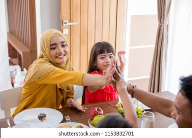 Family High Five And Put Hands Together While Having Breakfast