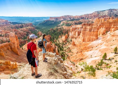 Family Hiking In Bryce Canyon National Park, Utah, USA Looking Out At A Scenic View