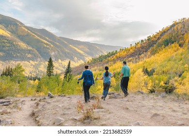 Family Hiking In The Mountains In Colorado During Fall Season 