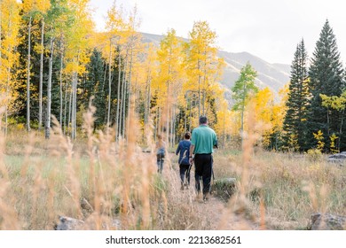 Family Hiking In The Mountains In Colorado During Fall Season 