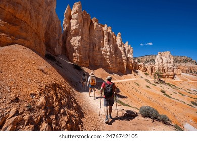 Family hiking in the mountains on summer vacation.  Friends hiking Fairyland Loop Trail. Bryce Canyon National Park, Utah, USA. - Powered by Shutterstock