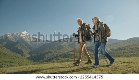 Family hiking in mountains travel adventure vacations group hikers couple trekking outdoor healthy lifestyle eco tourism 
