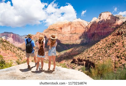 Family Hiking On Vacation, Relaxing On Top Of The Mountain, Looking At Beautiful  Mountains Scenery.  Zion National Park, Utah, USA