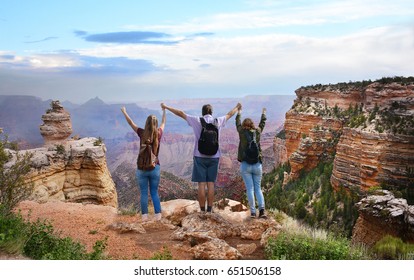 Family Hiking On Vacation,Family With Arms Raised Standing On Top Of The Mountain, Looking At Beautiful Summer Mountains Landscape. Grand Canyon National Park, Arizona, USA.