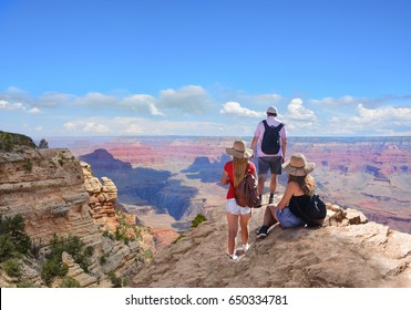 Family Hiking On Vacation,relaxing On Top Of The Mountain, Looking At Beautiful Summer Mountains Landscape. Grand Canyon National Park, Arizona, USA.