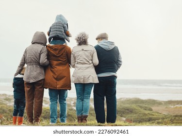 Family hiking outdoor, generations at beach together with nature view and back, spending quality time in winter. Grandparents, parents and children, love and care with people at the coast - Powered by Shutterstock