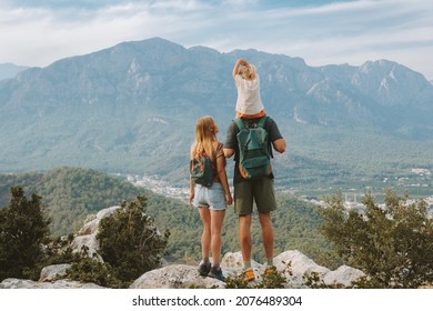 Family hiking parents with child outdoor travel in mountains active vacations lifestyle mother and father backpacking together with baby in Turkey