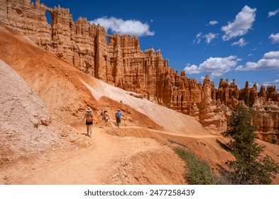 Family hiking in red mountains in Utah on summer vacation. Friends hiking Fairyland Loop Trail . Bryce Canyon National Park, Utah, USA. - Powered by Shutterstock