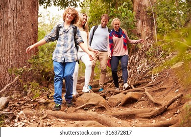 Family Hiking Through A Forest