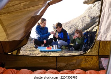 Family Of Hikings Having Breakfast Outside Tent