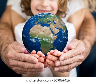 Family Holding 3D Planet In Hands. Earth Day Holiday Concept. Elements Of This Image Furnished By NASA