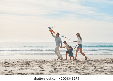 Family, holding hands and kite on beach together for holiday, travel or vacation in summer. Energy, love or running with mom, dad and children on sand at coast by ocean or sea for bonding or freedom - Powered by Shutterstock