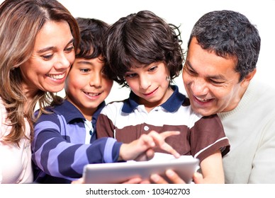 Family Holding A Tablet Computer And Looking At It