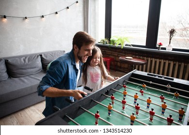 Family Holiday And Togetherness. Father And Daughter Playing Table Football At Home