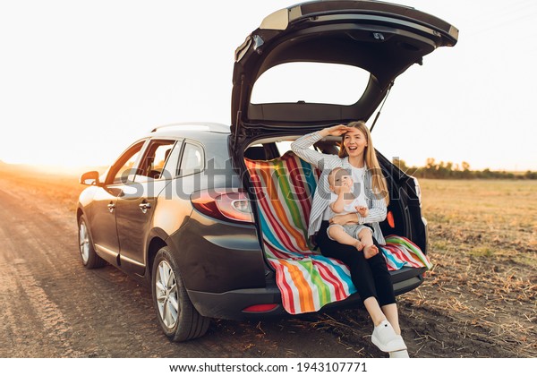 Family holiday and travel\
concept, summer vacation, happy family, mom and child enjoying the\
trip by car