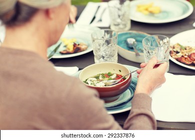 Family, Home, Dinner, Holidays And People Concept - Close Up Of Woman Eating Soup In Summer Garden