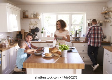 Family At Home Eating Breakfast In Kitchen Together