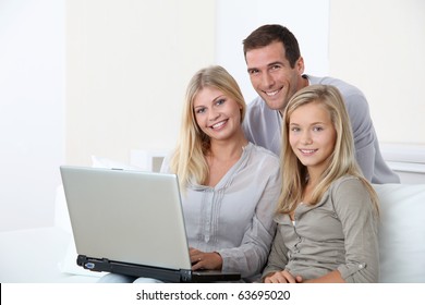 Family At Home In Front Of Computer