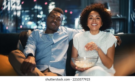 Family Home Movie Theatre. Loving Couple Enjoy Watching Comedy Movie And Eating Popcorn During The Evening. Boyfriend And Girlfriend Laughing And Talking About Favourite Comedian.