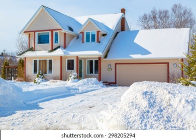 A Family Home In A North American Suburb Covered In Snow.