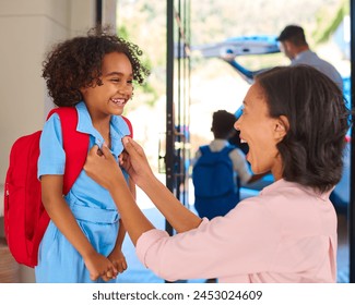 Family At Home With Parents Getting Children Ready To Leave House And Go To School - Powered by Shutterstock