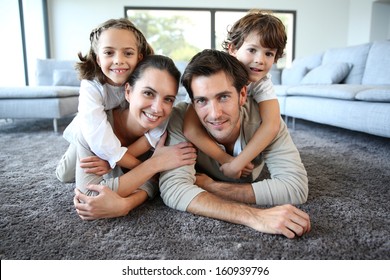 Family At Home Relaxing On Carpet
