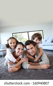 Family At Home Relaxing On Carpet