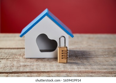 Family Home Security. Real Estate, Property Safety System. House With Heart Symbol And Combination Lock On Wooden Surface