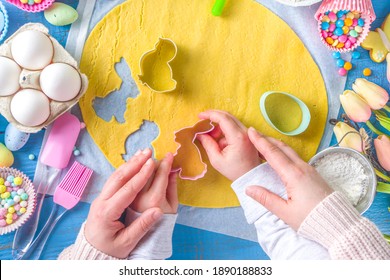 Family Homemade Holiday Easter Pastry Concept. Baking Background With Mom And Daughter Child Hands, Flatlay Top View. With Dough, Cupcake Forms, Cookie Cutters And Sugar Sprinkles, Ingredients