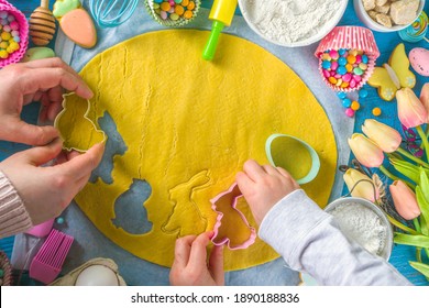 Family Homemade Holiday Easter Pastry Concept. Easter Baking Background With Mom And Daughter Child Hands, Flatlay Top View. With Dough, Cupcake Forms, Cookie Cutters And Sugar Sprinkles, Ingredients