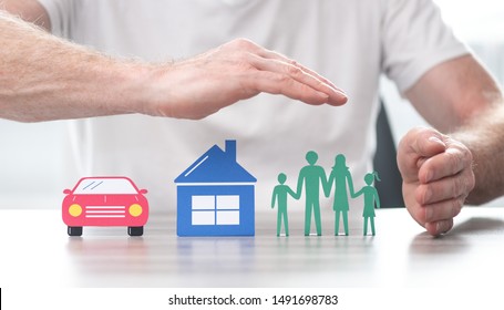 Family, house and car protected by hands - Concept of life, home and auto insurance