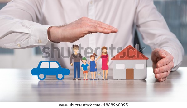 Family, house and car protected by hands -\
Concept of life, home and auto\
insurance