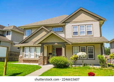 Family house with concrete pathway over the front yard - Powered by Shutterstock